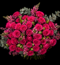 Bouquet of cerise pink roses, pink snapdragons, pink wax or erica, pink alstromeria and grey pennygum on a black background.